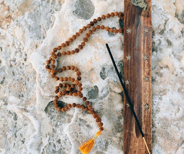 Silhouette of a person doing yoga against a sunrise.